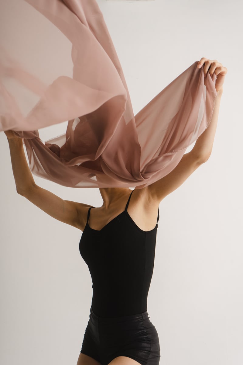 Female Dancer Covering Her Face with Fabric