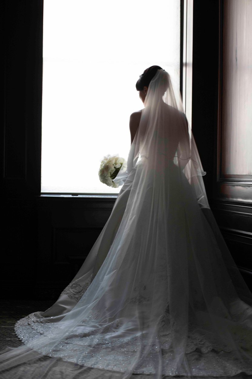 Back View of the Bride Standing Near the Window 